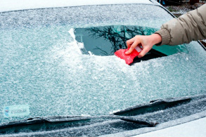 scraping off ice of windshield
