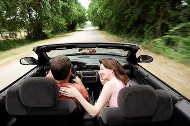 Couple driving in a convertible