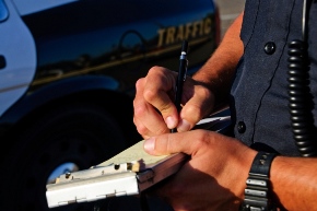 cop writing traffic ticket